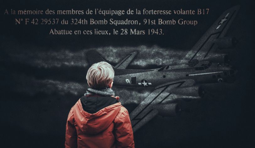 Un enfant devant la stèle commémorative du B-17 à Paluel.
